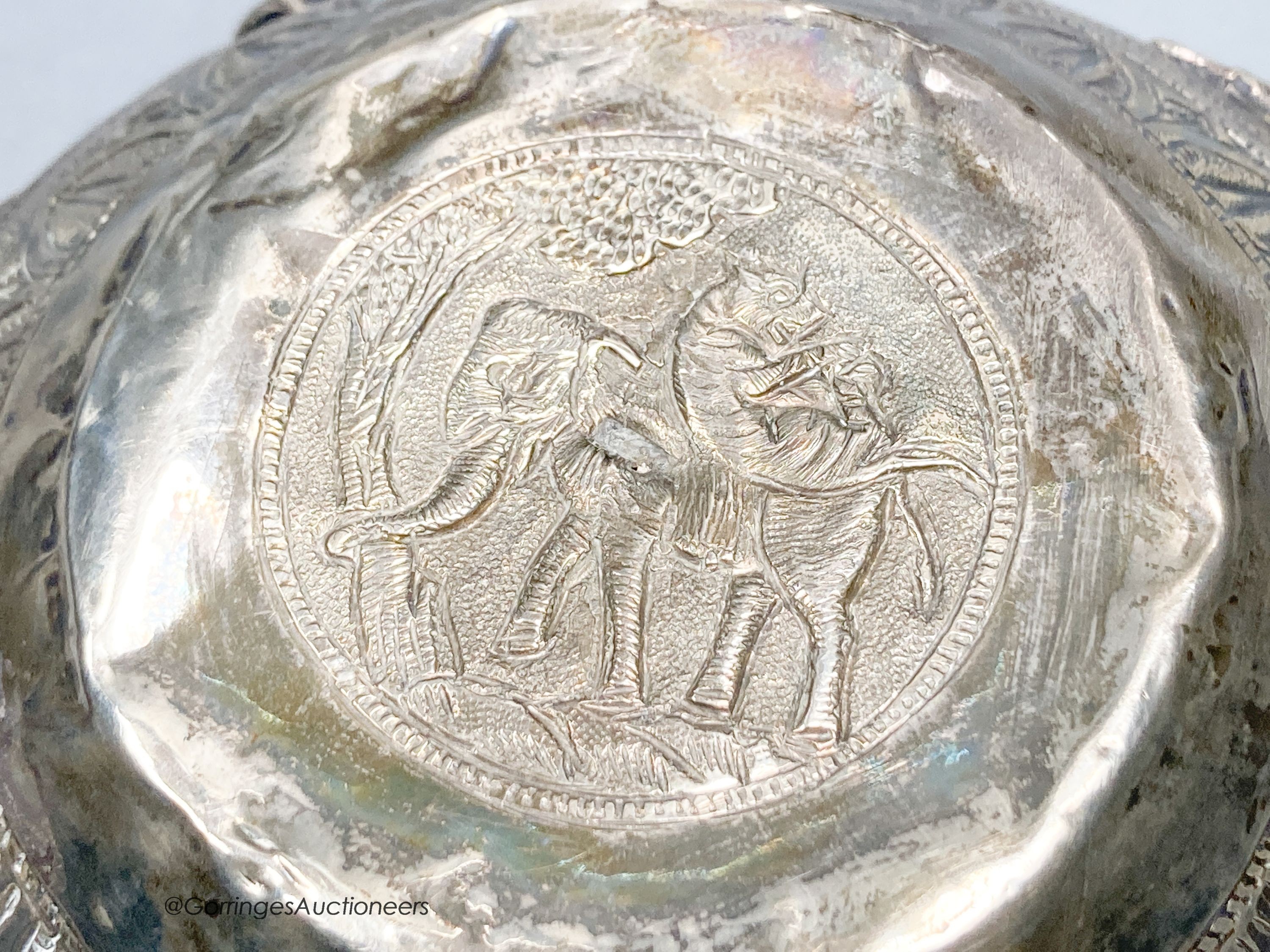 An Indian embossed white metal bowl, decorated with deities, height 8.5cm, 9oz.